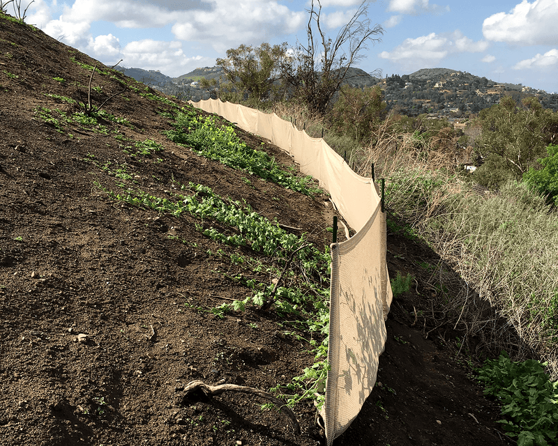 Load image into Gallery viewer, Tan evoguard pro 3x50 weather barrier on a hillside by grass and shrubs