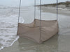 Beige weather barrier on a beach shore