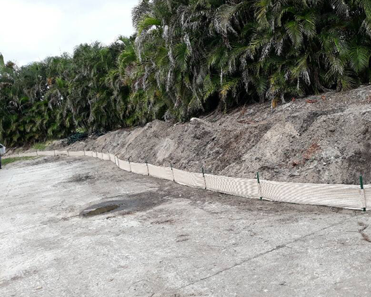 Tan evoguard weather barrier product setup next to dirt by palm trees